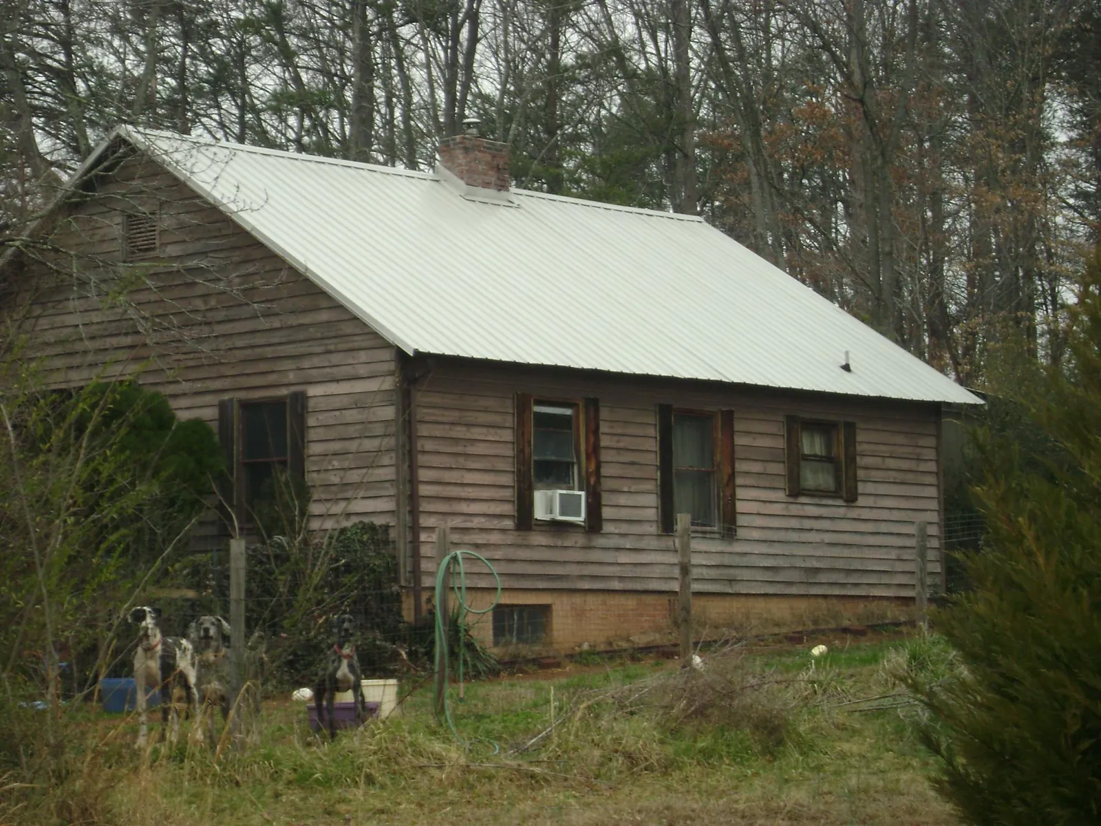 White metal roof on an old wood sided farmhouse, from a Metal Roof Installation job in Ashburnham